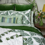 A hand-quilted Velvet Moss Quilt bed with green and white velvet bedding and pillows, created by Indian artisans, by John Robshaw. - 30395694972974