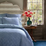 A blue and white bedroom with a Nandi Indigo Quilt bed featuring simple stripes by John Robshaw. - 30822520225838