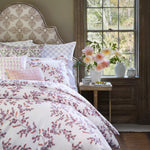A Gajara Lavender Euro bed with a floral pattern and a window by John Robshaw. - 30801423269934