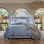 A Nandi Indigo Quilt bed in a bedroom with arched windows, featuring simple stripes. (Brand: John Robshaw) - 30783828459566