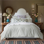 A bed in a bedroom with a John Robshaw Gajara Azure Euro duvet cover. - 30801452171310