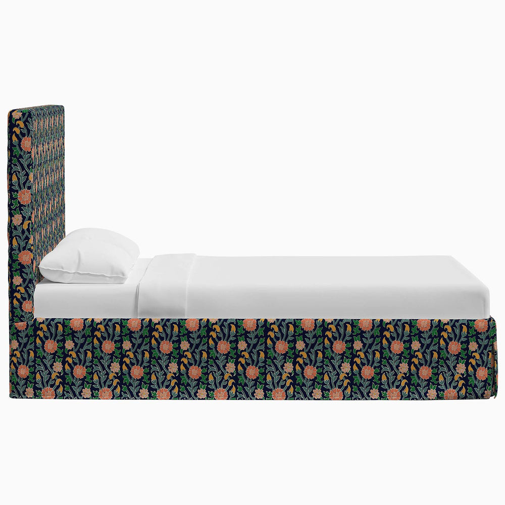 A Shona Bed with John Robshaw prints and fabrics, featuring an orange and black floral pattern.
