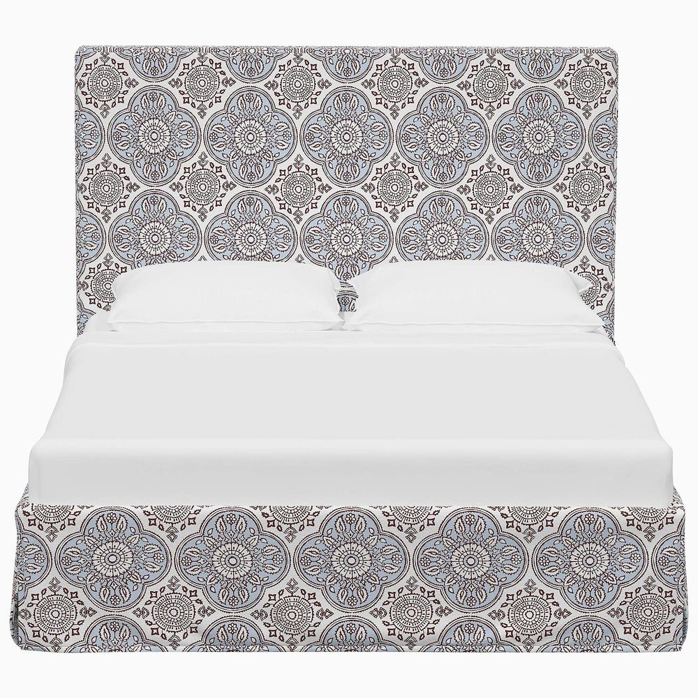 A Shona Bed by John Robshaw, with a blue and white paisley pattern, showcasing exquisite Shona prints on luxurious fabrics.