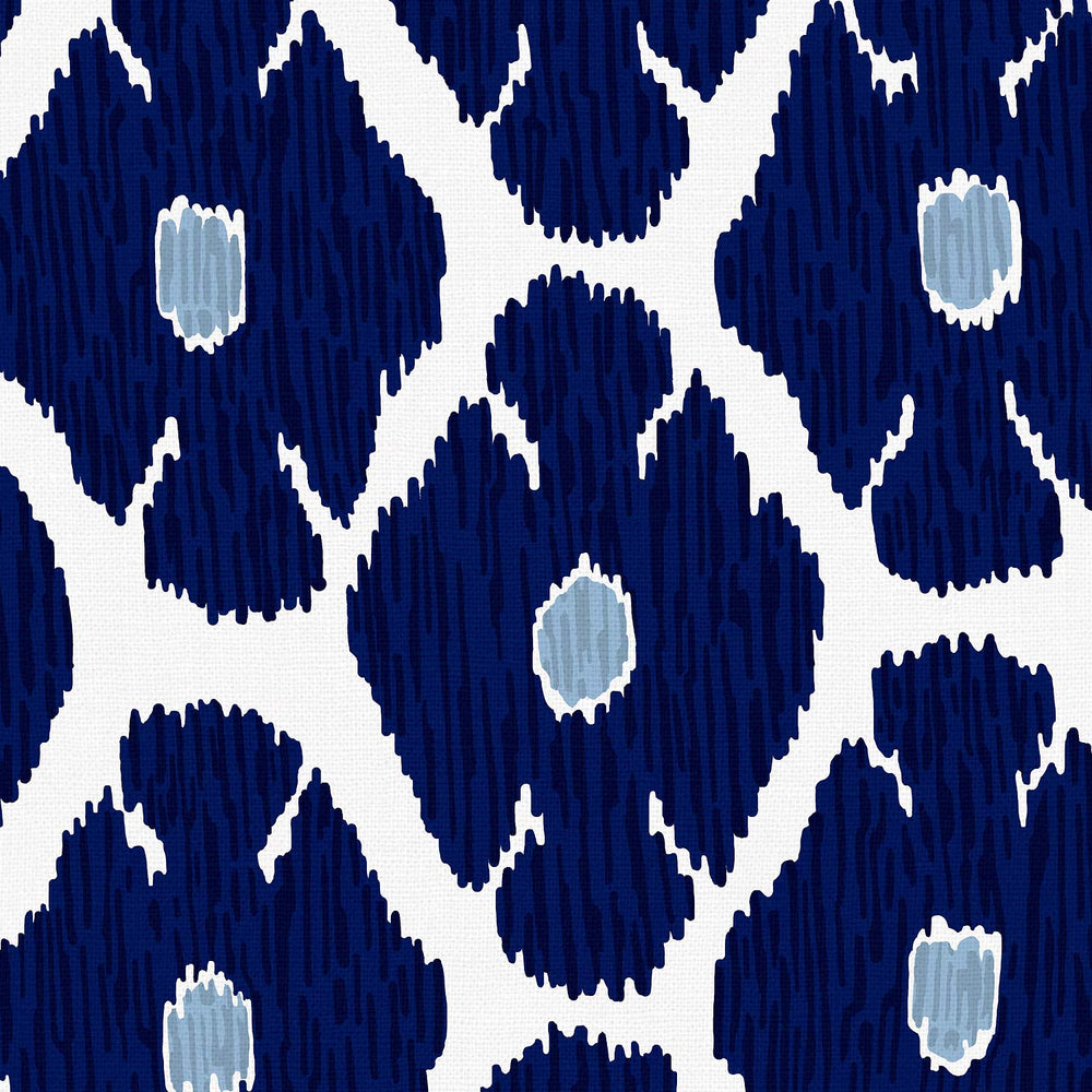 John Robshaw's Shona Bed features a blue and white ikat pattern on a white background.