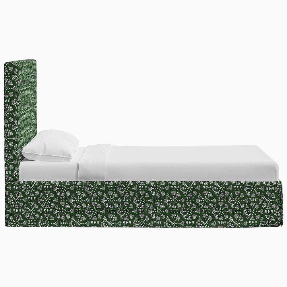A Shona Bed with a green and white John Robshaw pattern on it.