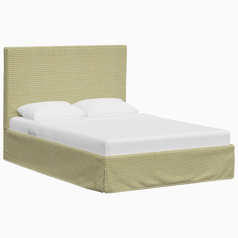 A Shona Bed with a green upholstered headboard and footboard made of fabrics by John Robshaw.