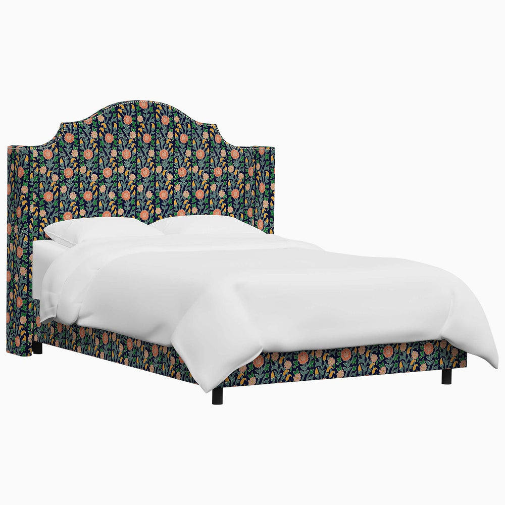 The John Robshaw Samrina bed features a floral upholstered headboard and footboard, inspired by Mughal arches.