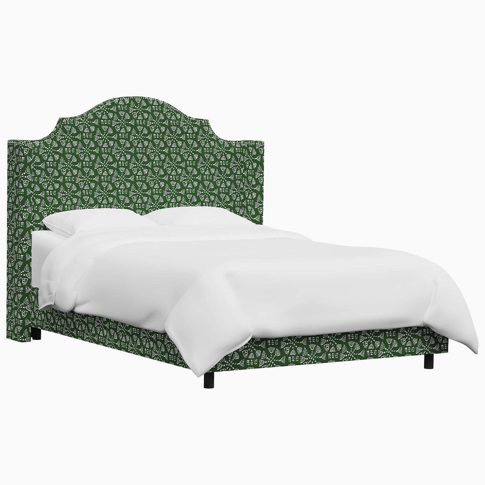 An elegant John Robshaw Samrina bed with a white headboard, upholstered in green fabric.