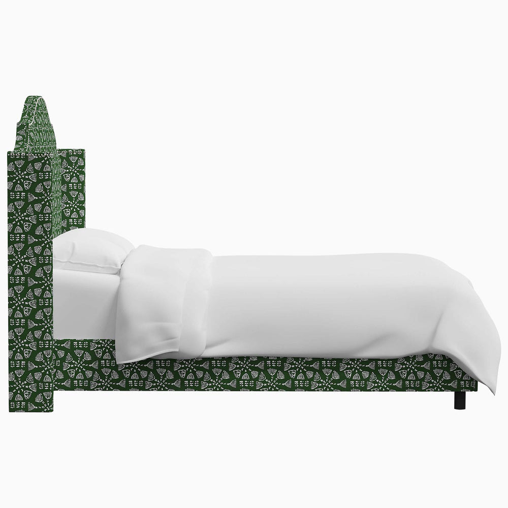 A green and white John Robshaw Samrina bed with a white headboard.