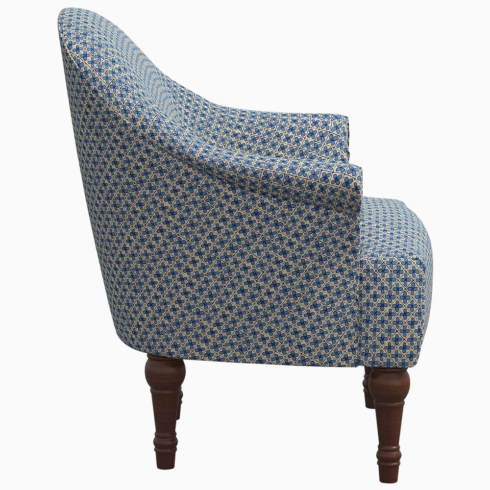 A John Robshaw Preeti Accent Chair with adventurous prints and wooden legs.