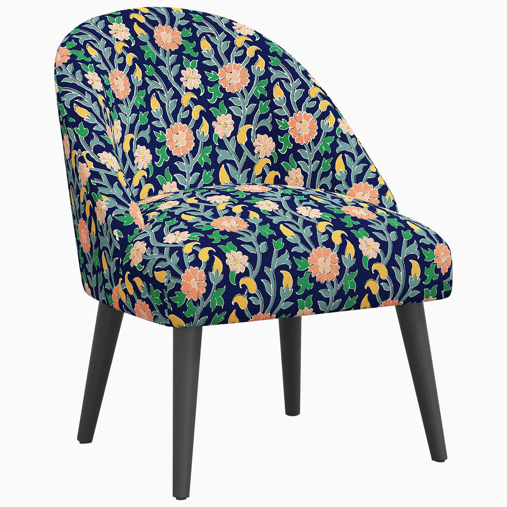 A Chetna Accent Chair with prints inspired by John Robshaw, and dark wood legs.