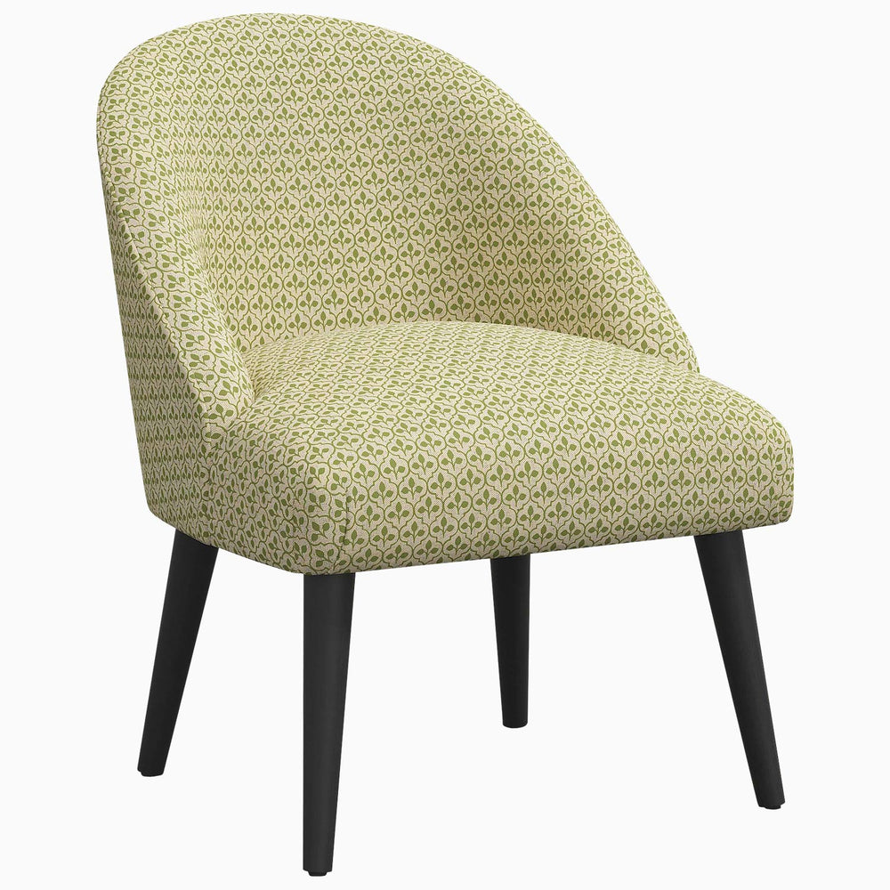 A Chetna Accent Chair by John Robshaw, with a green patterned design, mid-century silhouette, and black legs.