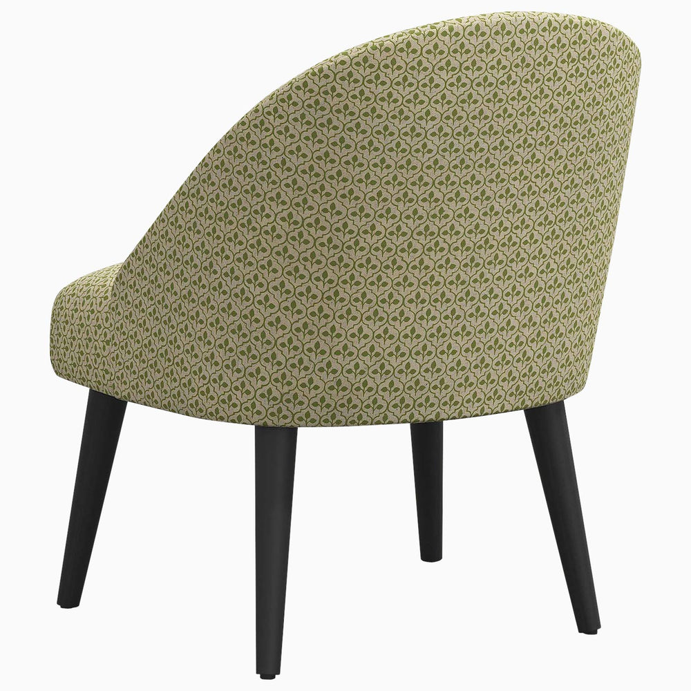 A green patterned Chetna Accent Chair with black legs, featuring prints inspired by John Robshaw and a mid-century silhouette.