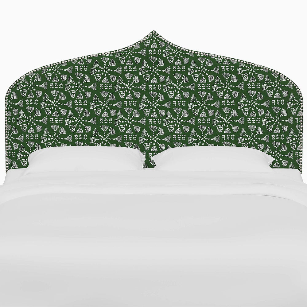 A bed with a John Robshaw Alina Headboard featuring green and white Mughal arches prints.