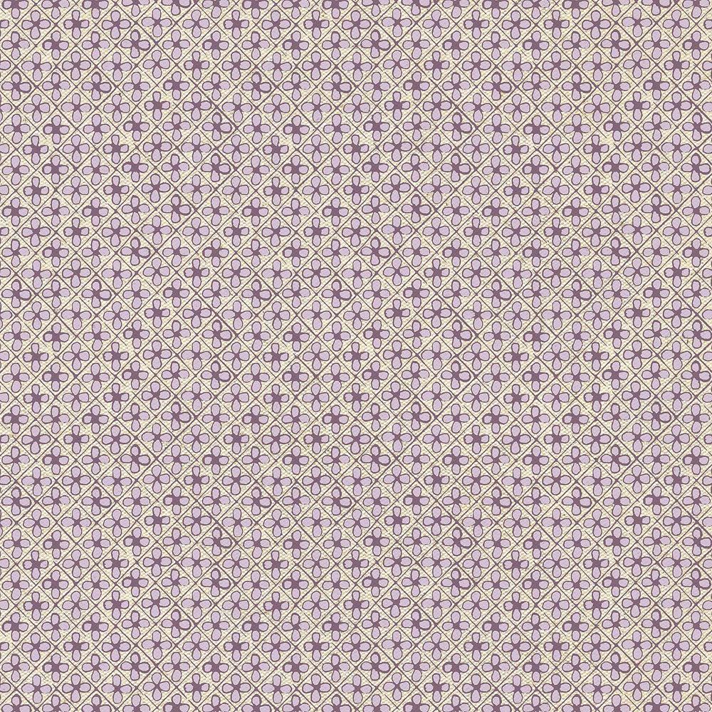 A purple and white polka dot pattern on a John Robshaw Shiza Ottoman in an interior setting.