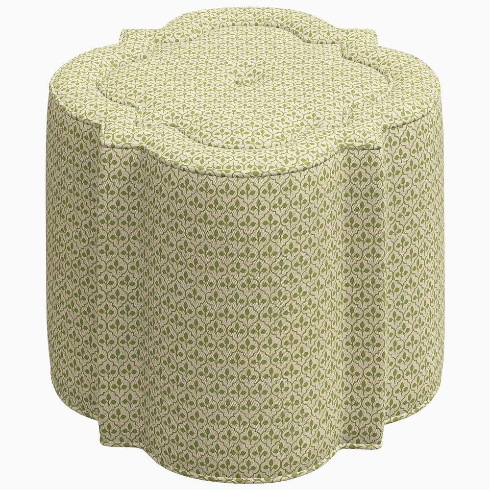 An interior Shiza Ottoman with a floral pattern swatch on a green stool by John Robshaw.