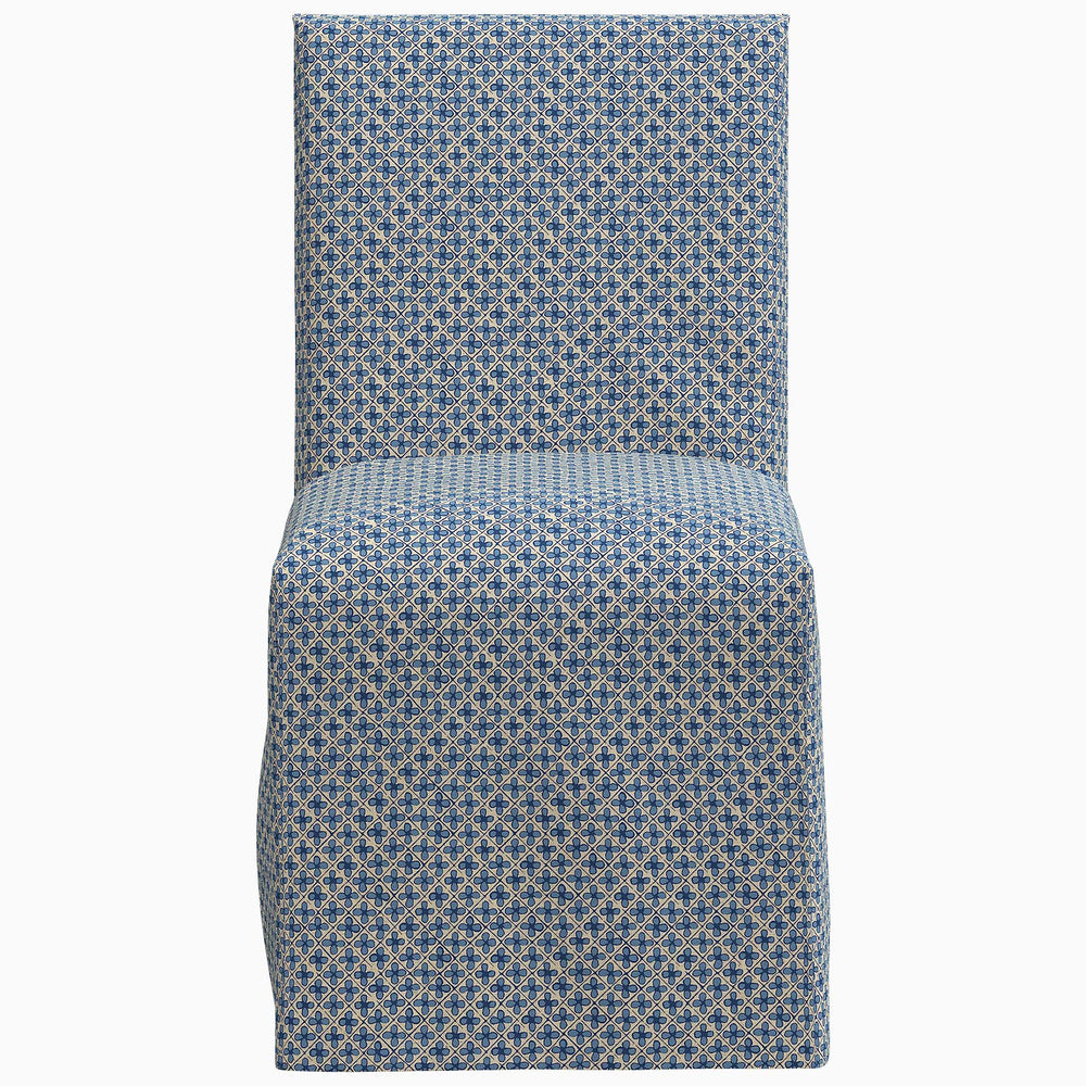 The John Robshaw Sadia Slipcover Chair is a stylish dining chair featuring a beautiful blue and white patterned slipcover.