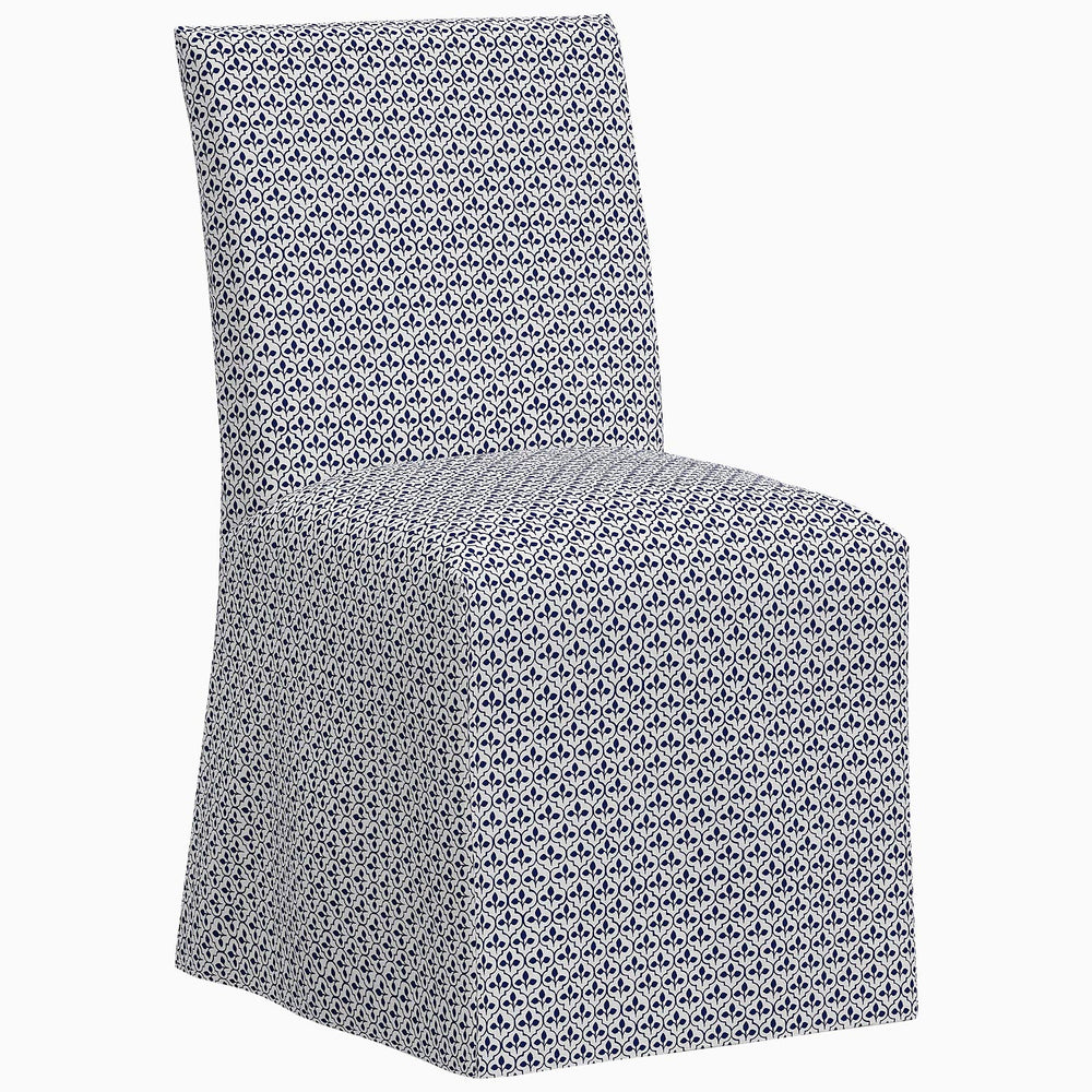 A John Robshaw Sadia Slipcover Chair, a blue and white dining chair with a slipcover.