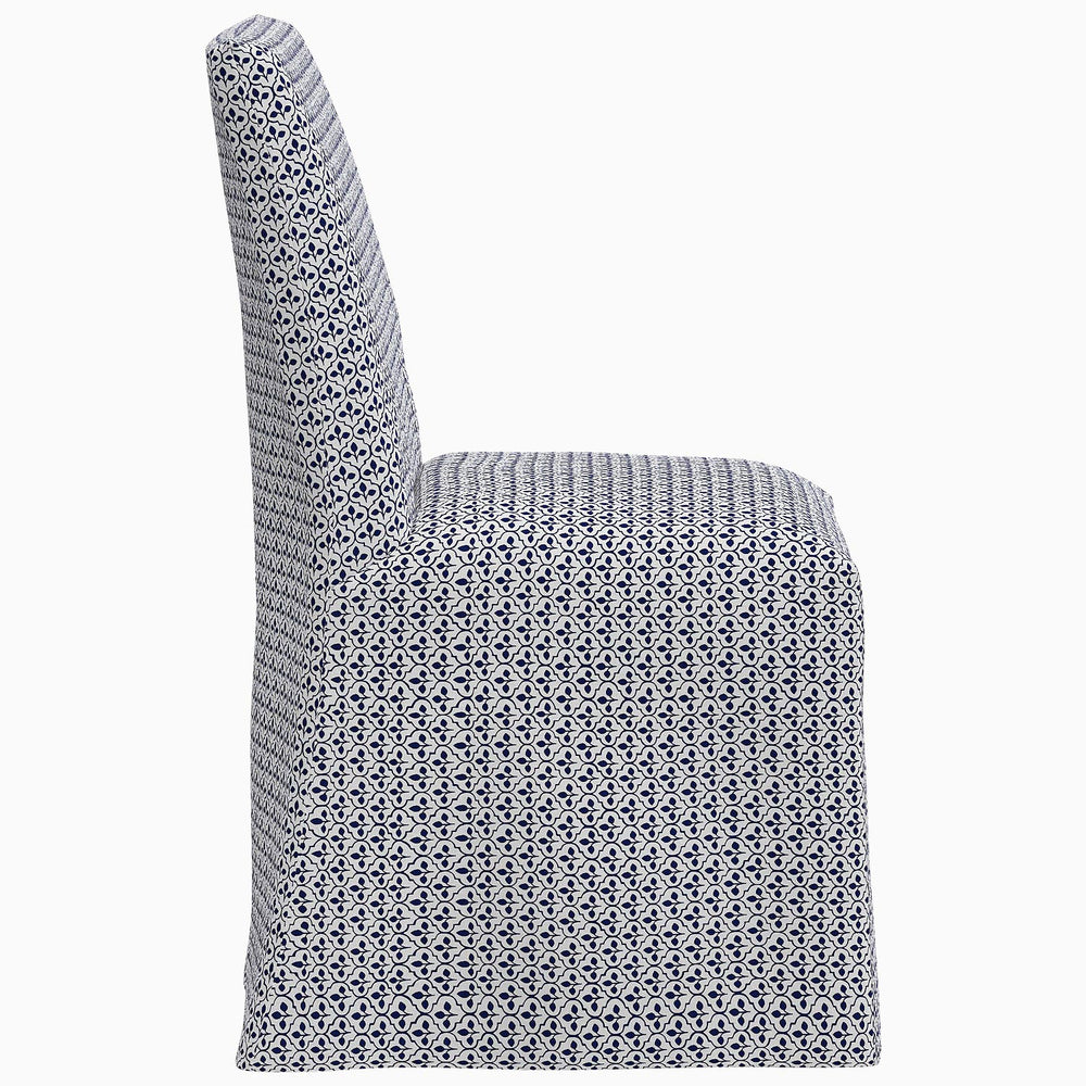 The John Robshaw Sadia Slipcover Chair is a dining chair with a blue and white pattern.