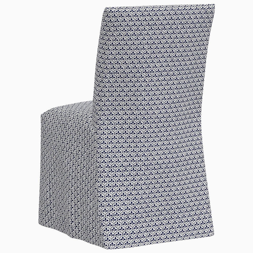 The John Robshaw Sadia Slipcover Chair is a stylish dining chair featuring a blue and white geometric pattern.