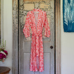 An Ishana Robe by John Robshaw, machine washable pink floral robe made of cotton voile, hanging on a door. - 30437794381870