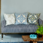 A Verdin Lapis Euro couch with John Robshaw blue pillows and a hand block printed potted plant. - 29385559932974