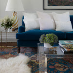 A blue couch with Hand Stitched White Decorative Pillows by John Robshaw in a living room. - 28220465348654