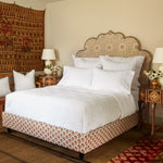 A bedroom with an John Robshaw's ornate bed adorned with John Robshaw's hand-stitched Organic Hand Stitched Light Indigo Quilt and a cotton voile rug. - 29588832387118