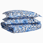 A stack of Zoya Azure Organic Duvet insert pillows in blue and white, made with 200 thread count organic cotton by John Robshaw. - 29980998664238