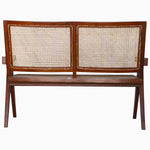 A Jeanneret Loveseat by John Robshaw with a rattan seat. - 29225395028014