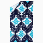 A blue and white Sashpura Indigo beach towel with an Ikat pattern hand-woven by Uzbekistan artisans, made by John Robshaw. - 29274367295534