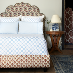 A bed with a Layla Azure Quilt headboard made of cotton voile from John Robshaw. - 30262778429486