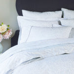 A bed with a Vamika Periwinkle Organic Duvet cover and pillows made from organic cotton, by John Robshaw. - 28806999769134