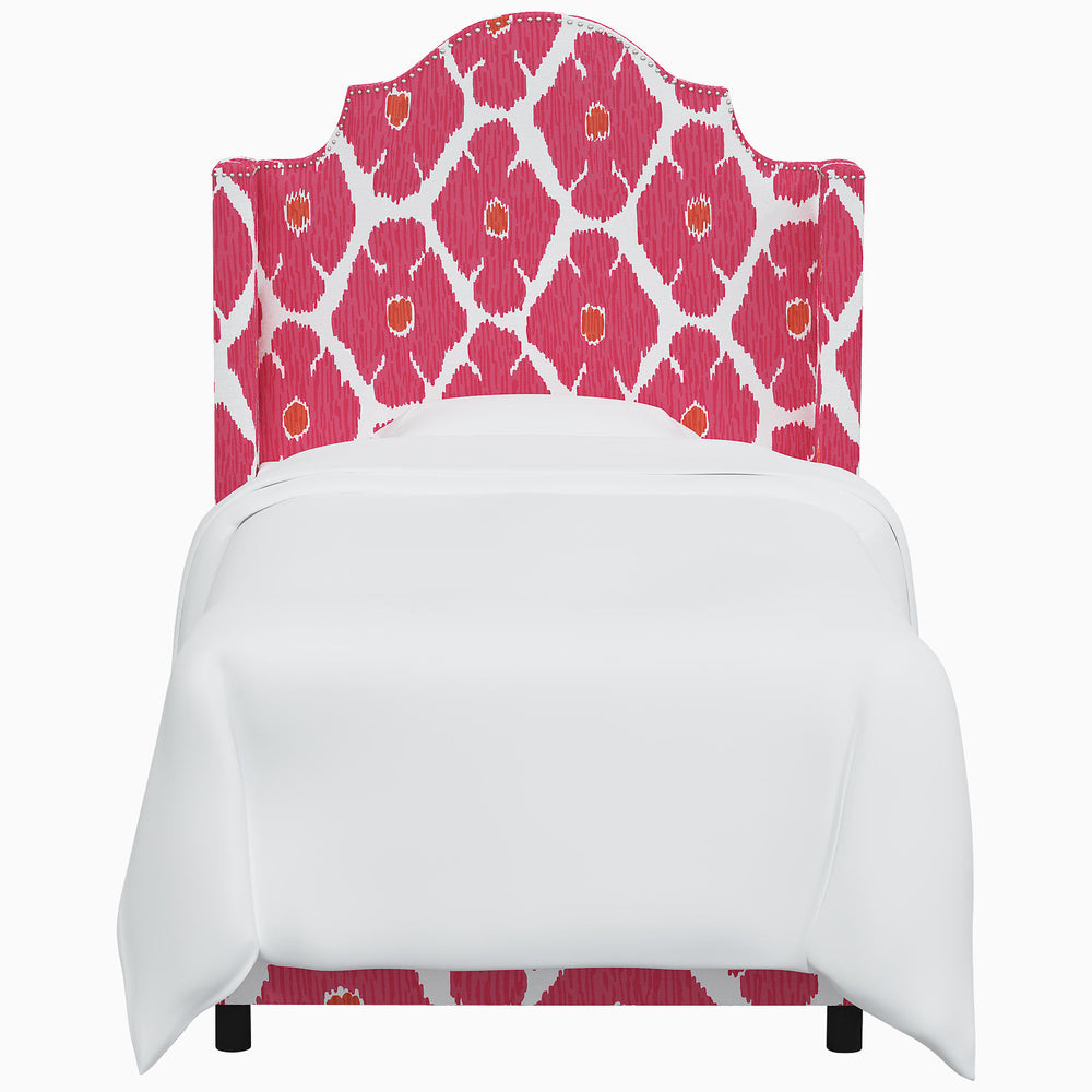 The John Robshaw Samrina Bed features a pink and white patterned headboard with intricate Mughal arches.
