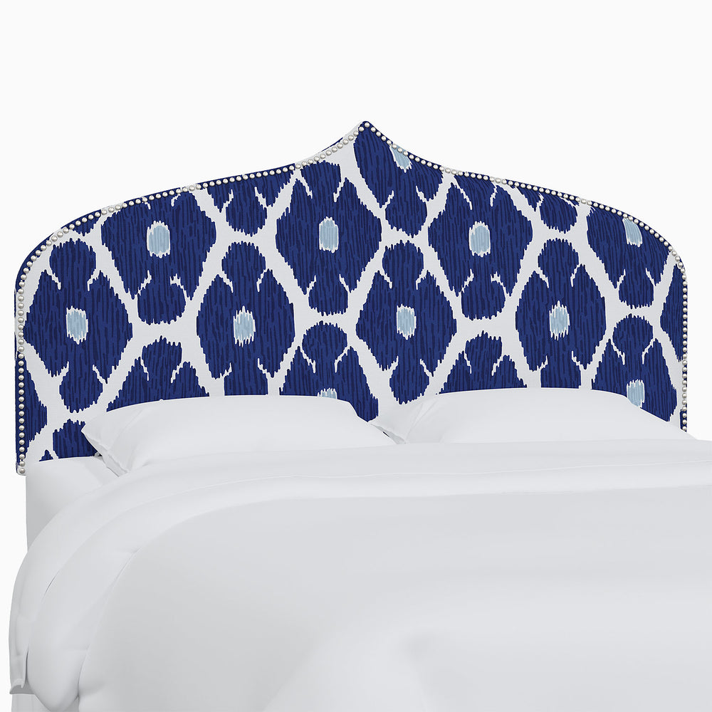 A John Robshaw Alina Headboard with blue and white patterned Mughal arches prints.