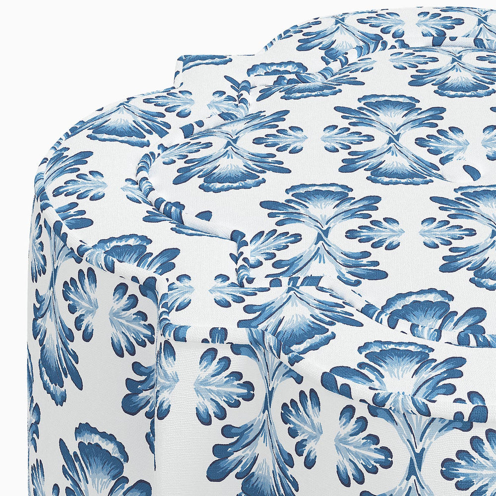 A blue and white Shiza Ottoman by John Robshaw with a floral pattern, perfect for adding a touch of elegance to any interior.