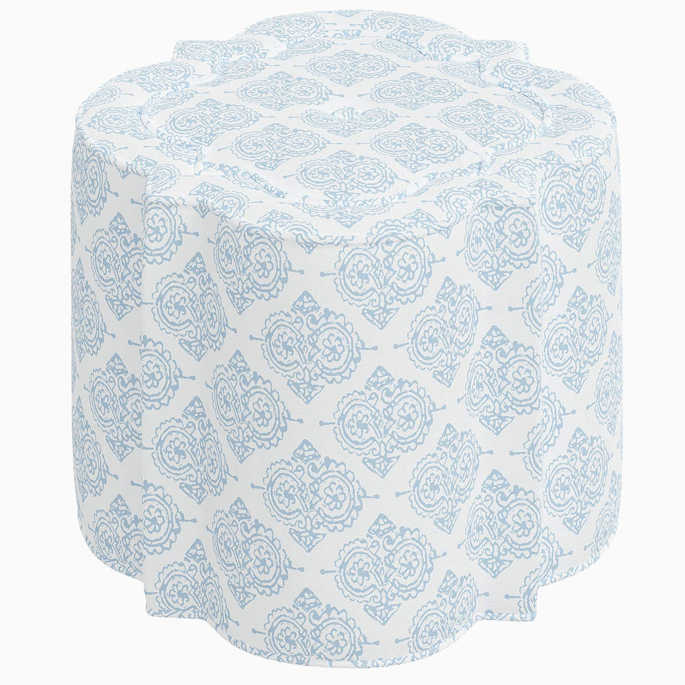A blue and white floral patterned Shiza Ottoman by John Robshaw table.