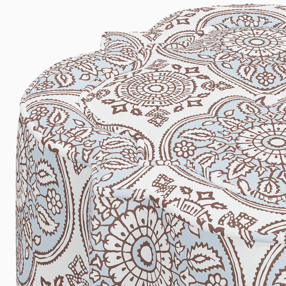 A Shiza Ottoman by John Robshaw with a blue and brown paisley swatch interior.