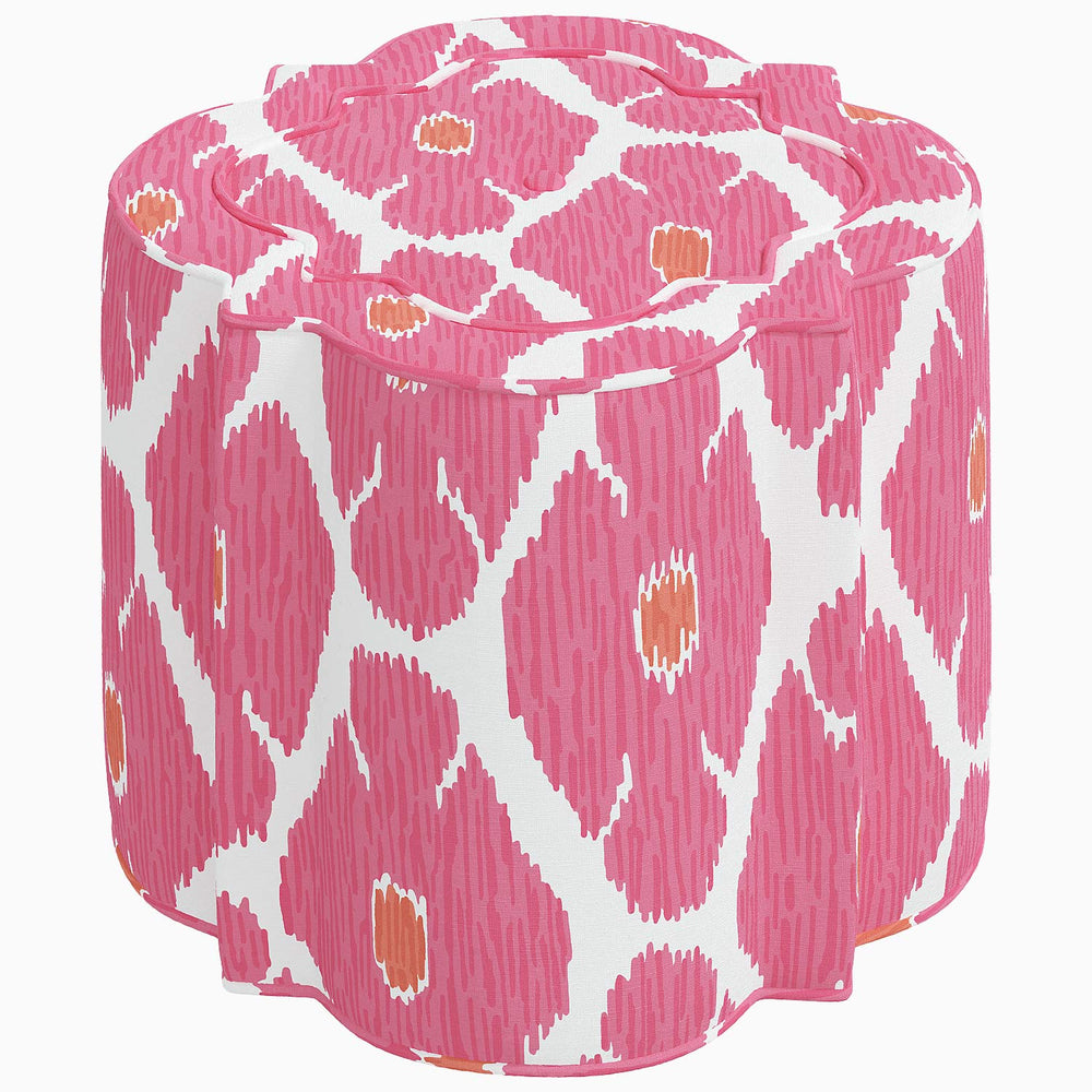 A patterned Shiza Ottoman by John Robshaw in pink and orange, perfect for adding a pop of color to any interior space.