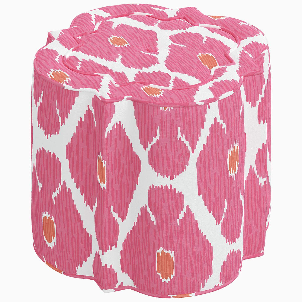 A vibrant Shiza Ottoman by John Robshaw with a pink and orange pattern.