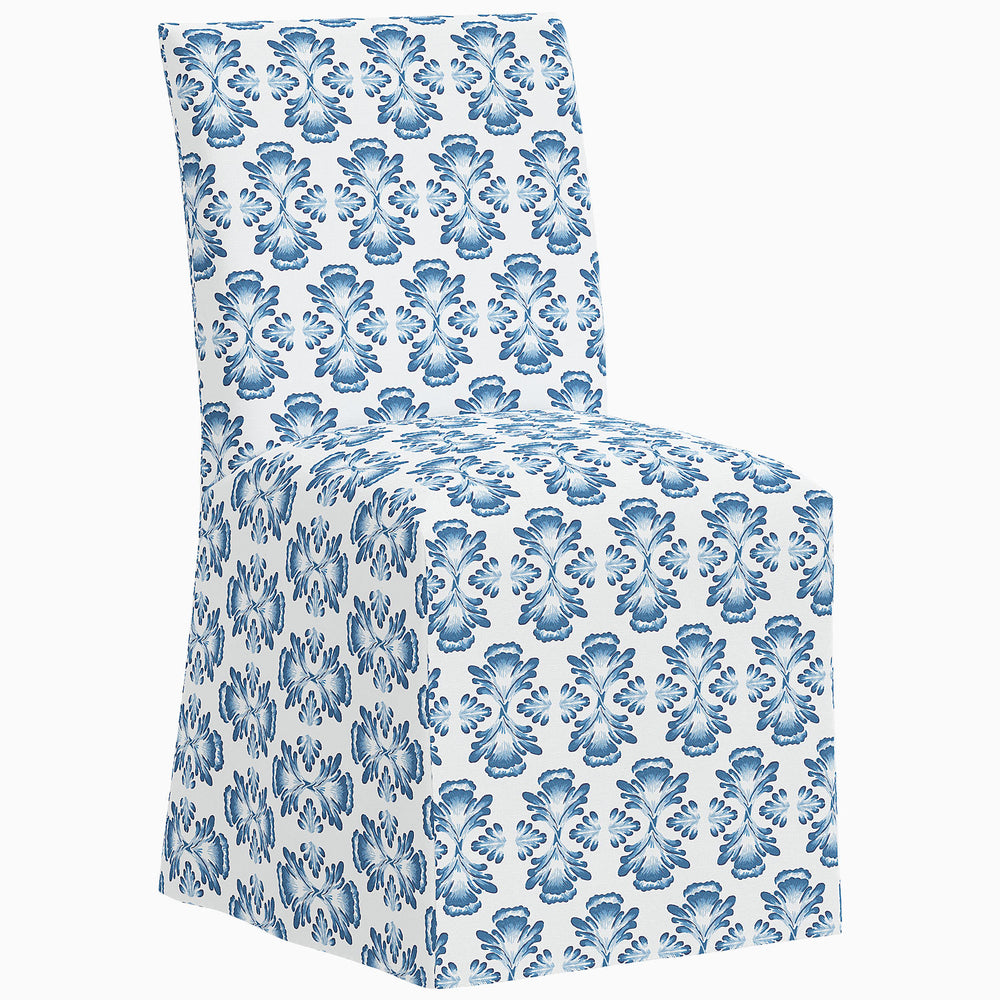 A John Robshaw Sadia Slipcover Chair with a blue and white floral pattern.