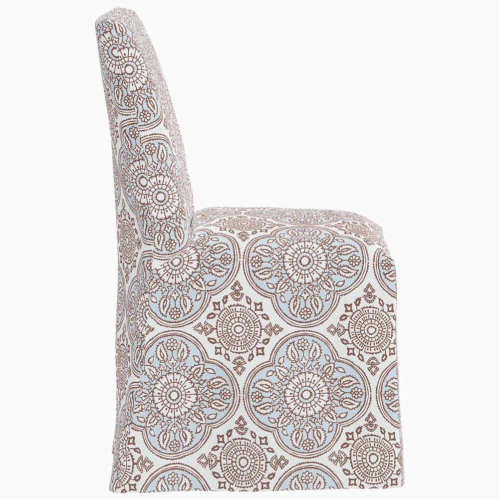 The John Robshaw Sadia Slipcover Chair is a dining chair with a blue and white paisley pattern.