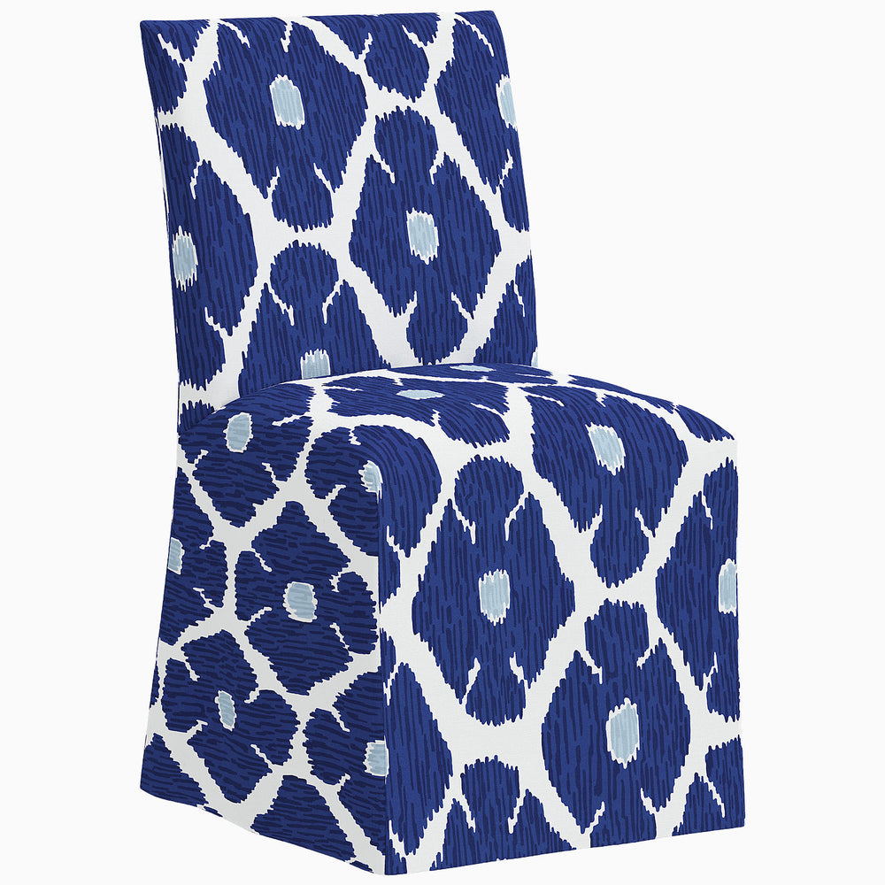 A John Robshaw Sadia Slipcover Chair with a blue and white patterned slipcover.