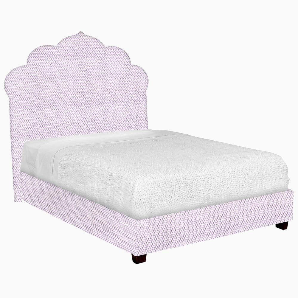 A John Robshaw Custom Bihar Bed with a purple headboard and footboard, upholstered in fabric.