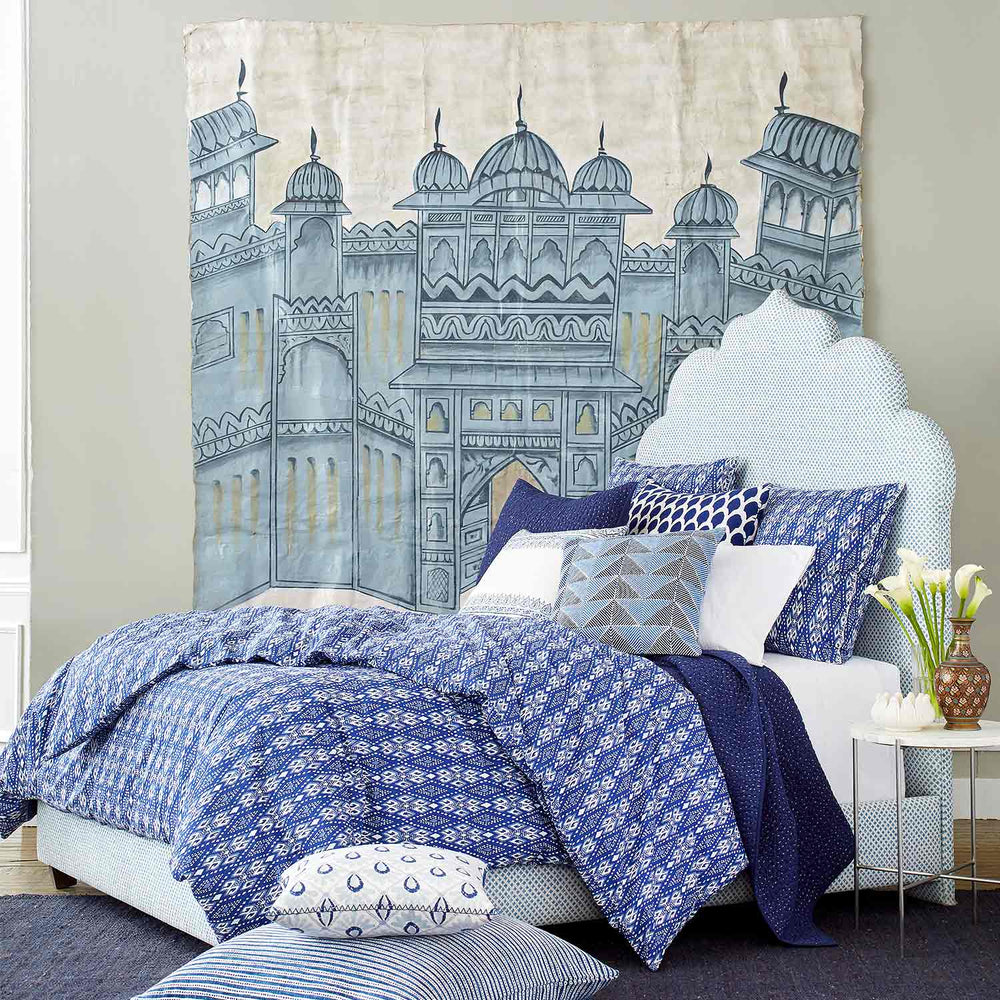 A John Robshaw Custom Bihar Bed with a fabric comforter.