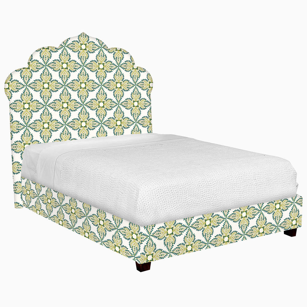 A John Robshaw Custom Bihar Bed adorned with a green and yellow floral pattern on the fabric.