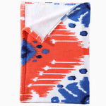 A Sashpura Coral Beach Towel by John Robshaw with an ikat pattern. - 29274367524910