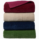 A stack of four John Robshaw Velvet Berry Quilt blankets on top of each other. - 30497705689134