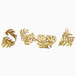 Four Gold Fern Napkin Rings (Set of 4) with raised metal on a white background by John Robshaw. - 30405347049518