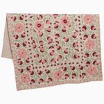 A pink and green Tejal Berry Throw with flowers on it in Suzani print by John Robshaw. - 30395670102062